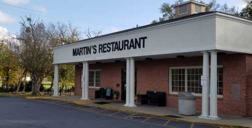 Exterior of Martin's Restaurant, featuring a brick facade, large sign, and columns at the entrance.