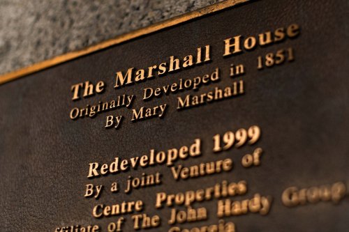 Plaque detailing the history of The Marshall House, originally developed in 1851 by Mary Marshall, redeveloped in 1999.