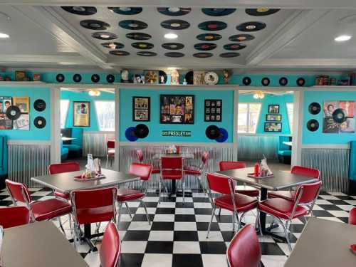 Retro diner interior with checkered floor, red booths, and walls decorated with vinyl records and music memorabilia.