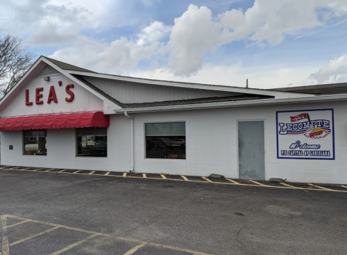 Exterior of Lea's restaurant with a red awning and a sign for LeCompte, located in a parking lot.