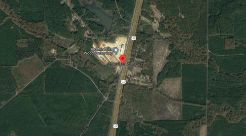 Aerial view of Electric Mills, Mississippi, showing roads, wooded areas, and nearby facilities.