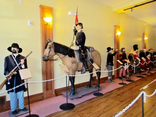 A museum display featuring a soldier on horseback and various historical figures in military attire.