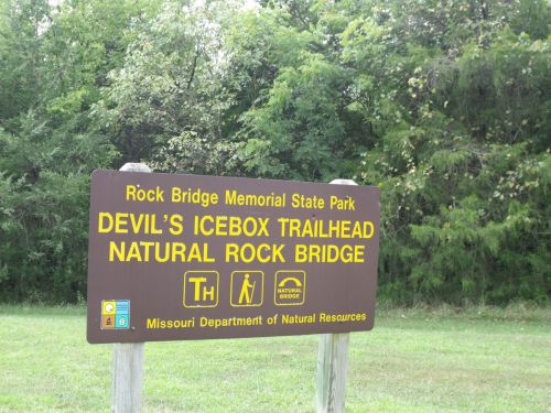 Sign for Devil's Icebox Trailhead at Rock Bridge Memorial State Park, featuring natural rock bridge information.
