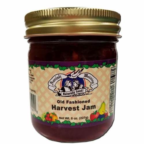 A jar of Old Fashioned Harvest Jam with a colorful label featuring fruits and a logo for Amish Wedding.