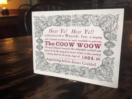 A decorative sign announcing "The Coow Woow," a cocktail from 1664, at Longfellow's Wayside Inn.