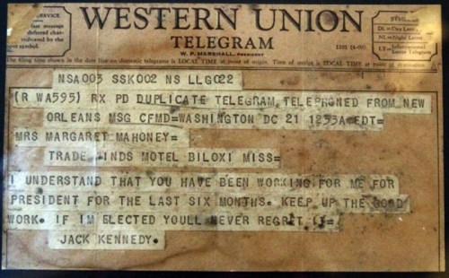 A vintage Western Union telegram addressed to Mrs. Margaret Mahoney, signed by Jack Kennedy, discussing work and support.