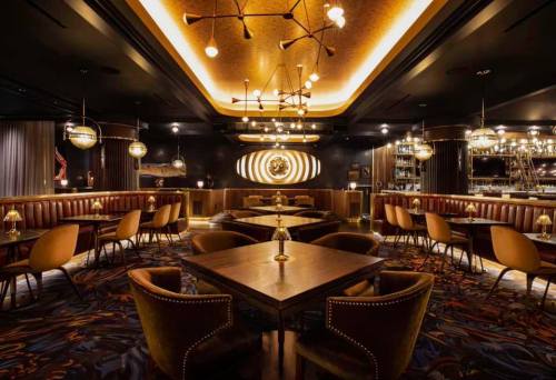 Elegant restaurant interior with warm lighting, plush seating, and stylish decor, creating a cozy atmosphere.