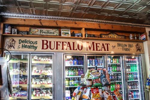 A store display featuring a sign for "Buffalo Meat" with various products and beverages in the background.