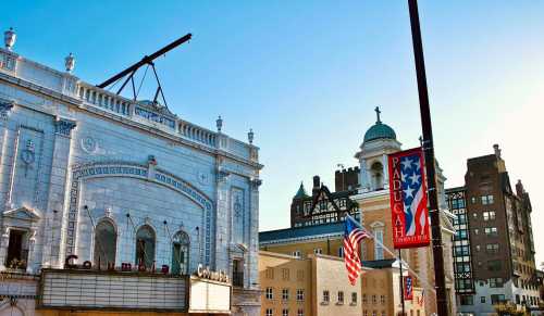 Historic buildings in Paducah, Kentucky, with flags and a clear blue sky in the background.