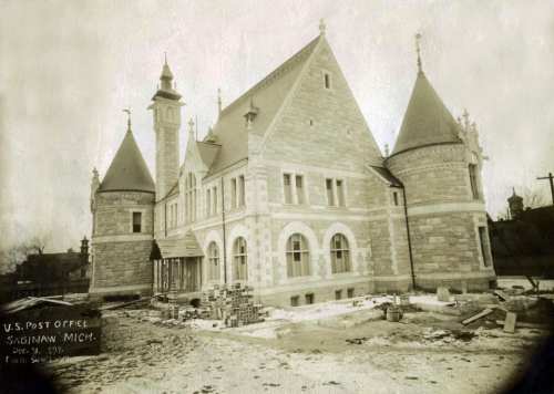 Historic U.S. Post Office building in Saginaw, Michigan, under construction, featuring unique architectural details.