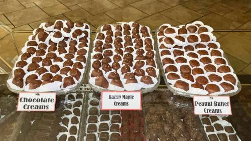 Trays of assorted chocolates labeled: Chocolate Creams, Bacon Maple Creams, and Peanut Butter Creams.
