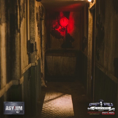 A dimly lit, eerie hallway with a red light at the end, featuring worn walls and a haunting atmosphere.
