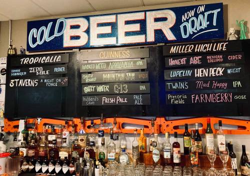 A bar menu displaying various beers and spirits, with "Cold Beer Now on Draft" prominently featured at the top.