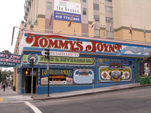 Colorful exterior of Tommy's Joynt, a restaurant featuring vibrant murals and signage, located in San Francisco.