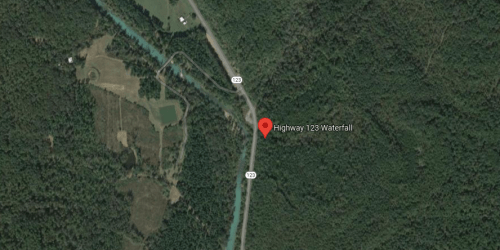 Map view showing Highway 123 with a marker for a waterfall location, surrounded by dense forest.