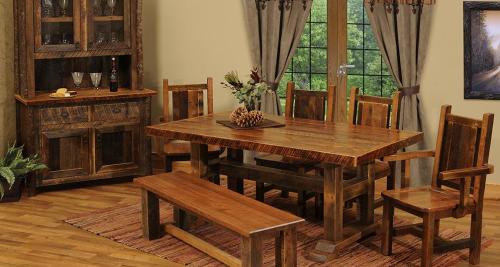 A rustic wooden dining room set with a large table, six chairs, and a sideboard, surrounded by natural light.