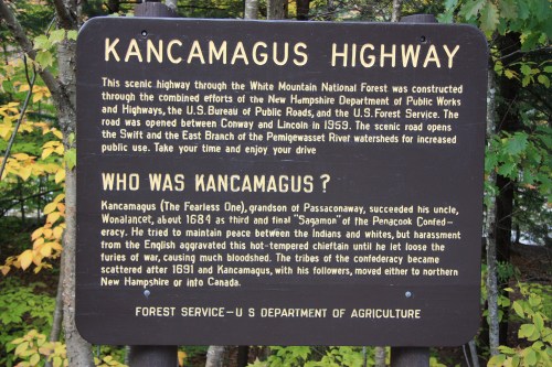 Sign for Kancamagus Highway, detailing its history and connection to the White Mountain National Forest.