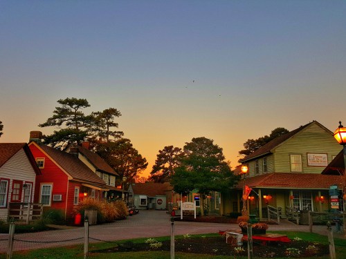 Charming buildings at sunset, with trees and a clear sky in the background, creating a peaceful atmosphere.