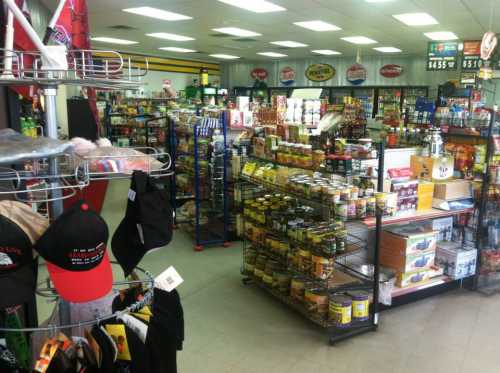 A well-stocked convenience store aisle with shelves of snacks, drinks, and merchandise.