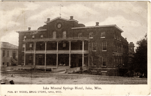 Historic black-and-white photo of the Iuka Mineral Springs Hotel in Iuka, Mississippi, showcasing its grand architecture.