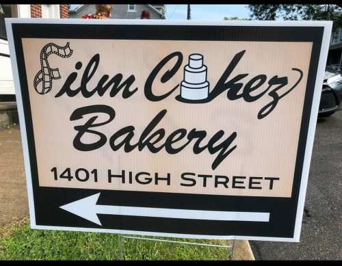Sign for "Film Citez Bakery" with an arrow pointing left, located at 1401 High Street.