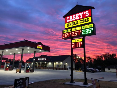 A Casey's General Store with a colorful sunset, displaying fuel prices for unleaded and diesel.