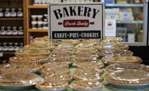 A display of various baked goods, including pies and cookies, under a sign that reads "Bakery Fresh Daily."