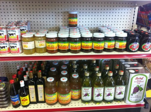 Shelves filled with various jars, sauces, and bottles, featuring colorful labels and a variety of condiments.