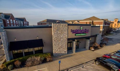 Exterior view of Las Margaritas Mexican Restaurant, featuring a stone facade and outdoor seating area.