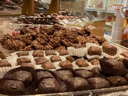 A display of assorted chocolates and confections, including chocolate-covered treats and nut clusters.