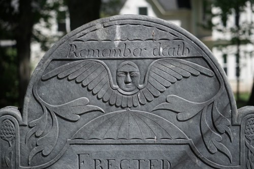 A gravestone featuring an angel with wings and the inscription "Remember death."
