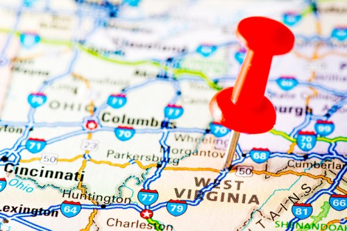 A close-up of a map with a red pushpin marking West Virginia.