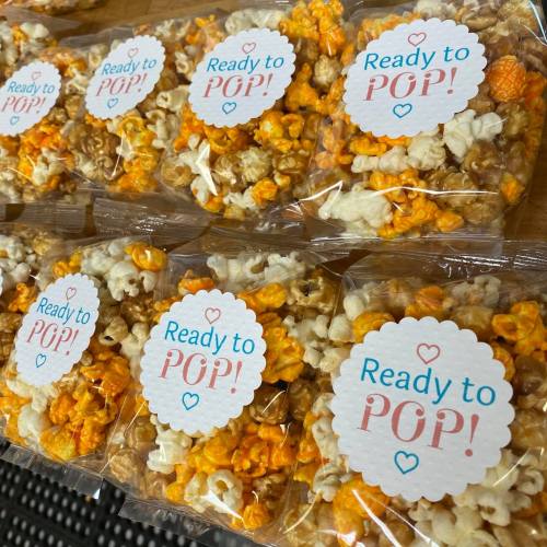 Bags of popcorn in orange and white, each labeled "Ready to POP!" in playful pink text.