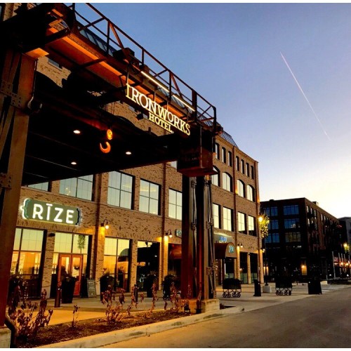 Exterior of Ironworks Hotel at sunset, featuring modern architecture and a welcoming entrance.