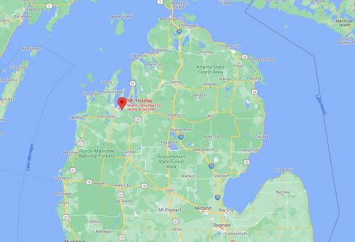 Map of Michigan highlighting Mt. Holiday, a ski area near Traverse City, with surrounding forests and lakes.