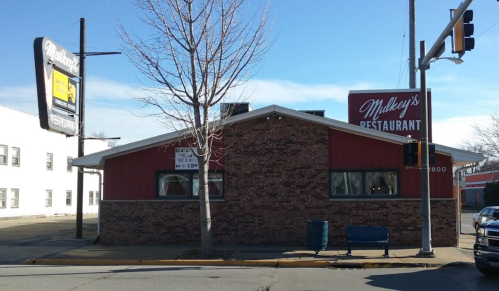 Exterior view of Mulkey's Restaurant, a brick building with a sign, located at a street corner.