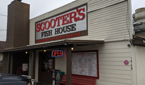 Exterior of Scooter's Fish House, featuring a sign that reads "Open" and a menu displayed outside.