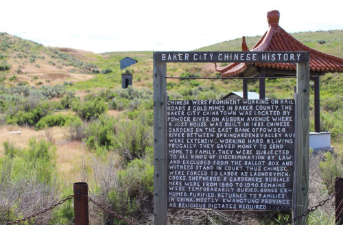 Sign detailing the history of Chinese workers in Baker City, highlighting their contributions and hardships in the area.