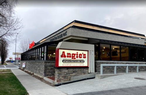 Exterior of Angie's restaurant, featuring a stone facade and a sign that reads "where the locals eat."