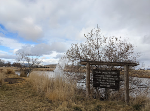 A sign near a pond reads "Old Perpetual," with a fountain and grassy landscape under a cloudy sky.