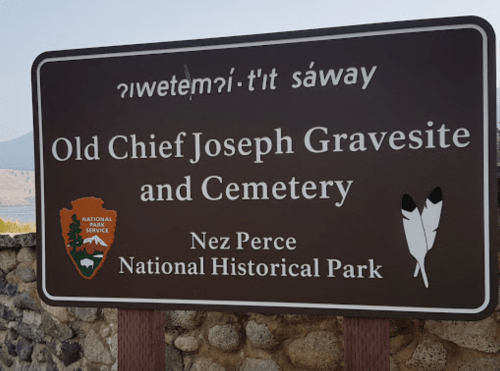 Sign for Old Chief Joseph Gravesite and Cemetery at Nez Perce National Historical Park, featuring a park service logo.