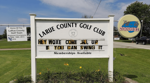 Sign at LaRue County Golf Club reads: "Hey Woxe come fill up if you can swing it. Memberships available."