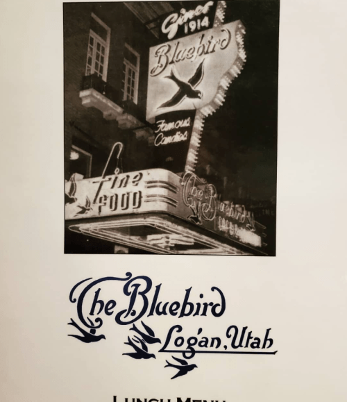 Black and white image of The Bluebird restaurant sign in Logan, Utah, with "Lunch Menu" text below.