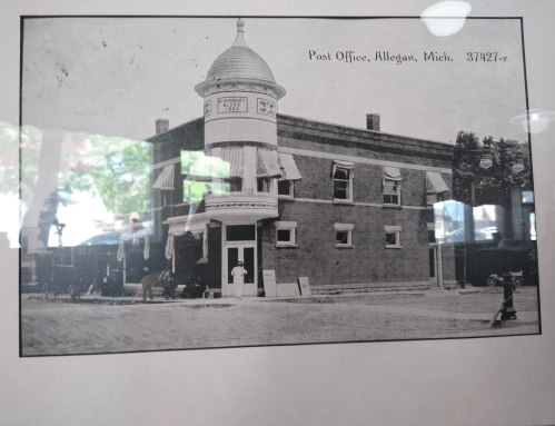Historic black-and-white photo of the Allegan, Michigan post office, featuring a distinctive tower and horse-drawn carriage.