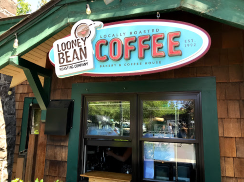 Sign for Looney Bean Coffee, a bakery and coffee house, featuring "Locally Roasted Coffee" and established in 1992.