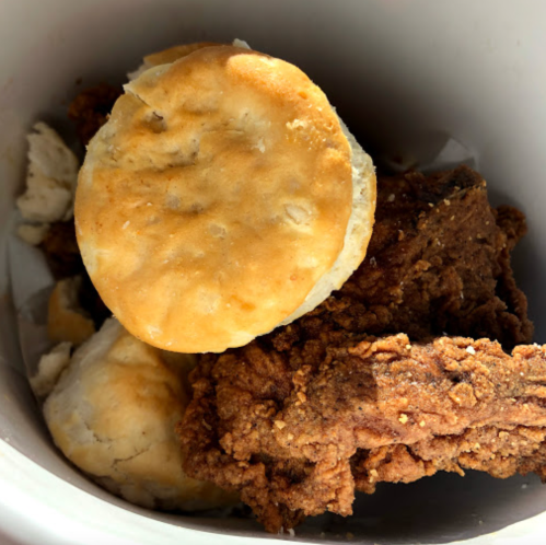A container filled with golden biscuits and crispy fried chicken pieces.