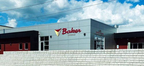 Exterior of a modern building with a sign that reads "Baker College," featuring a gray and red color scheme.
