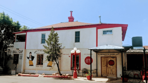 Exterior of the Red Ball Café, featuring a white building with red accents and a welcoming entrance.