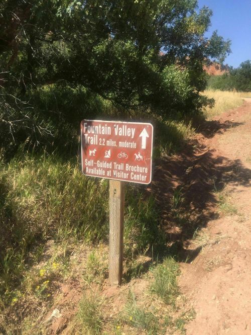 Sign for Fountain Valley Trail, 2.2 miles, moderate difficulty, with info on self-guided trail brochure at visitor center.