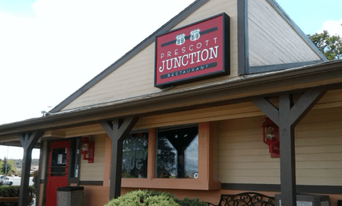 Exterior of Prescott Junction Restaurant, featuring a sign and a welcoming entrance with wooden accents.